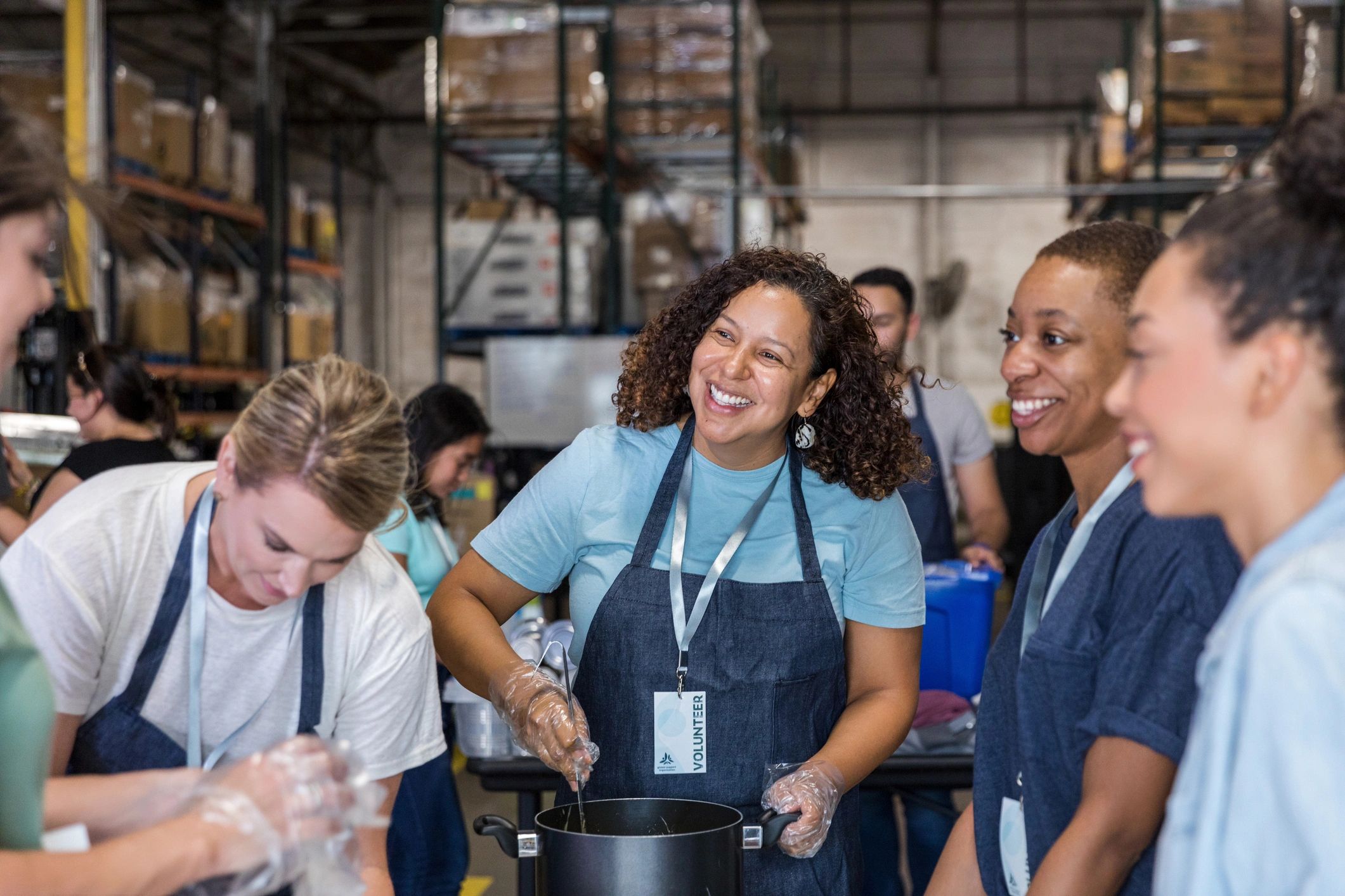 Team members preparing food together in a community kitchen