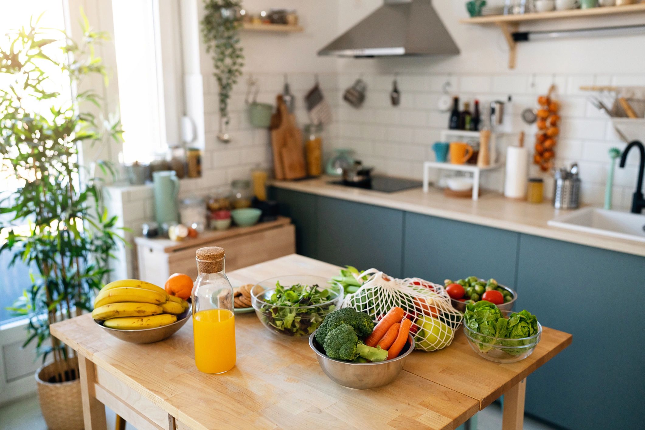 Fresh fruits and vegetables arranged in a modern kitchen