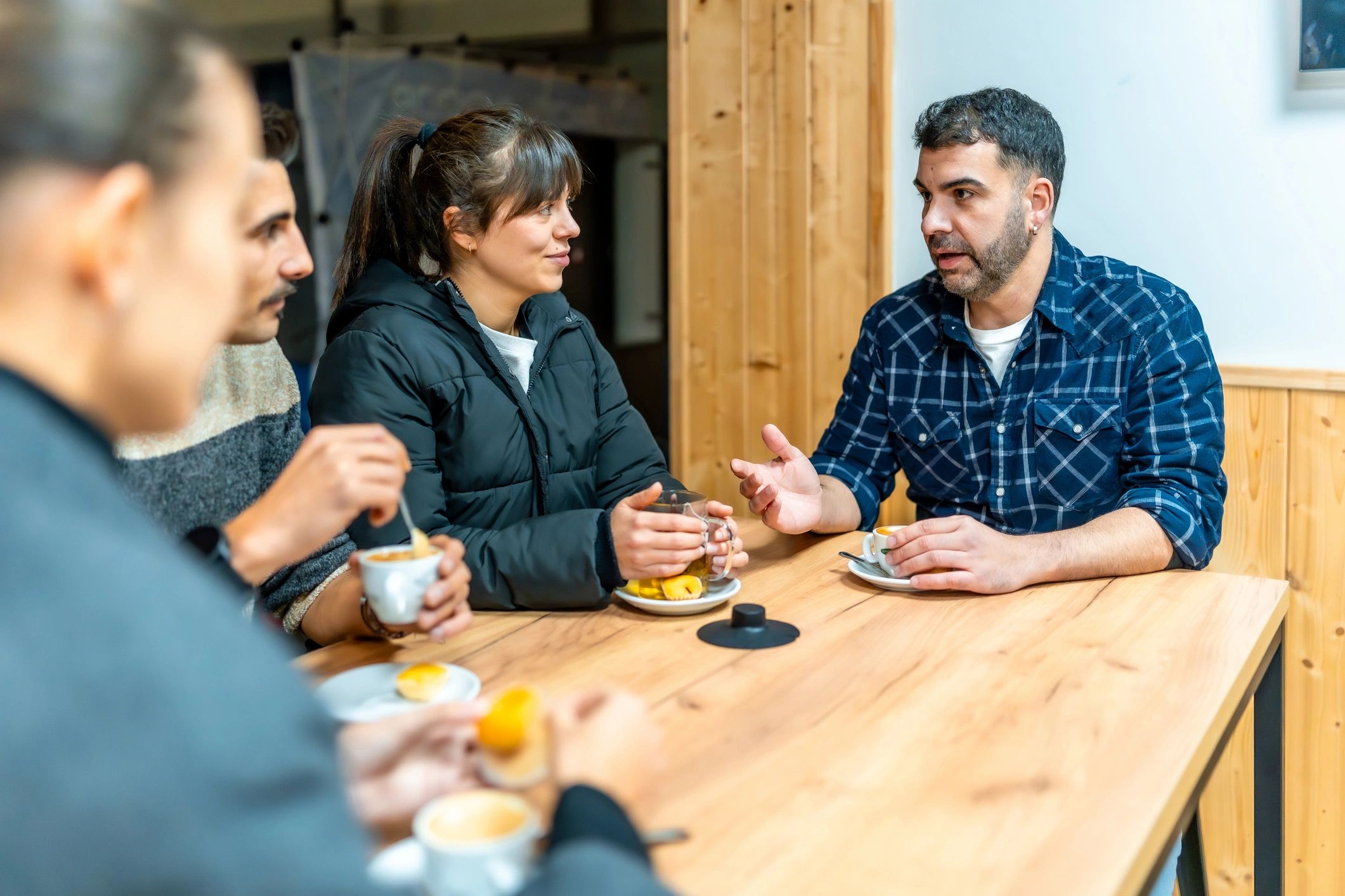 Community members gathered in a café setting for conversation